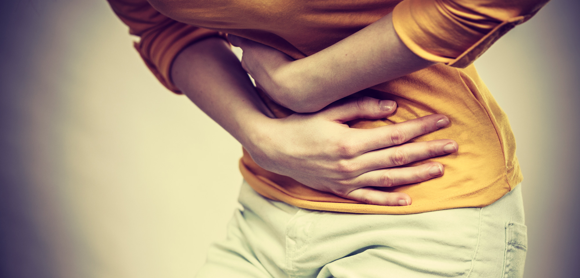 Woman holds upset stomach