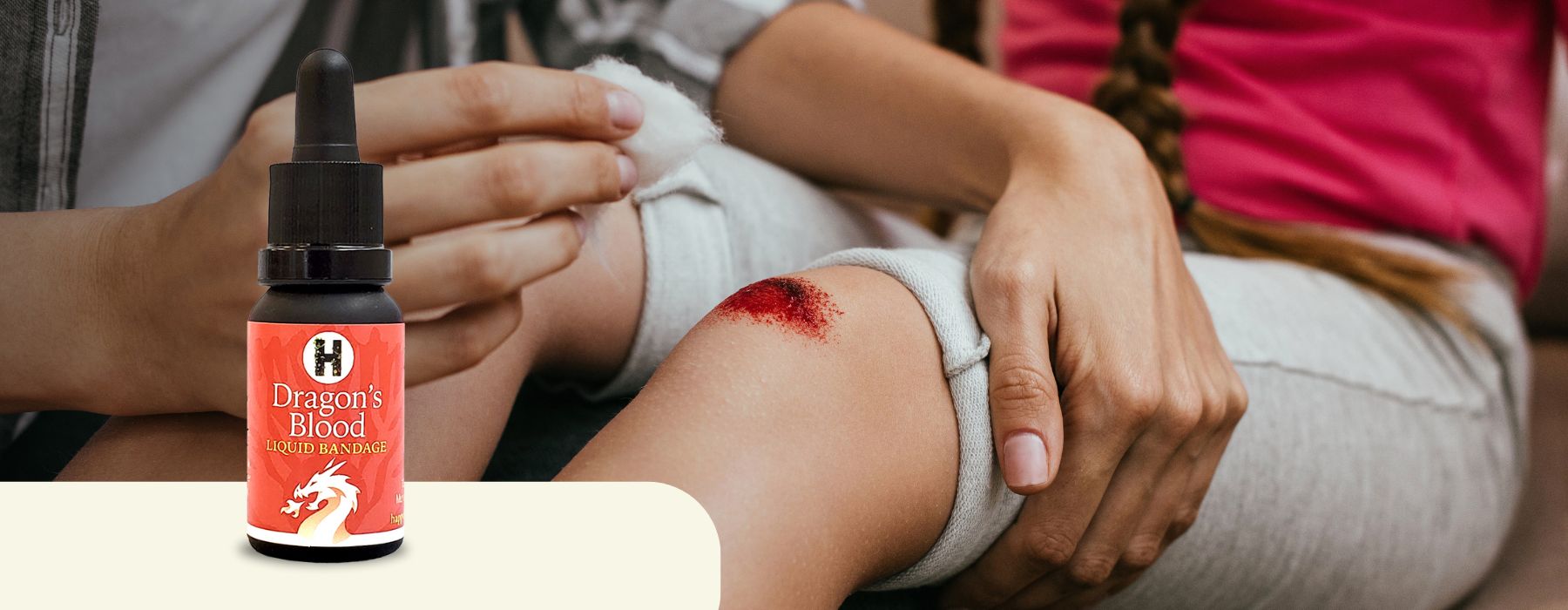 Bottle of Dragon's Blood in front of scraped knee